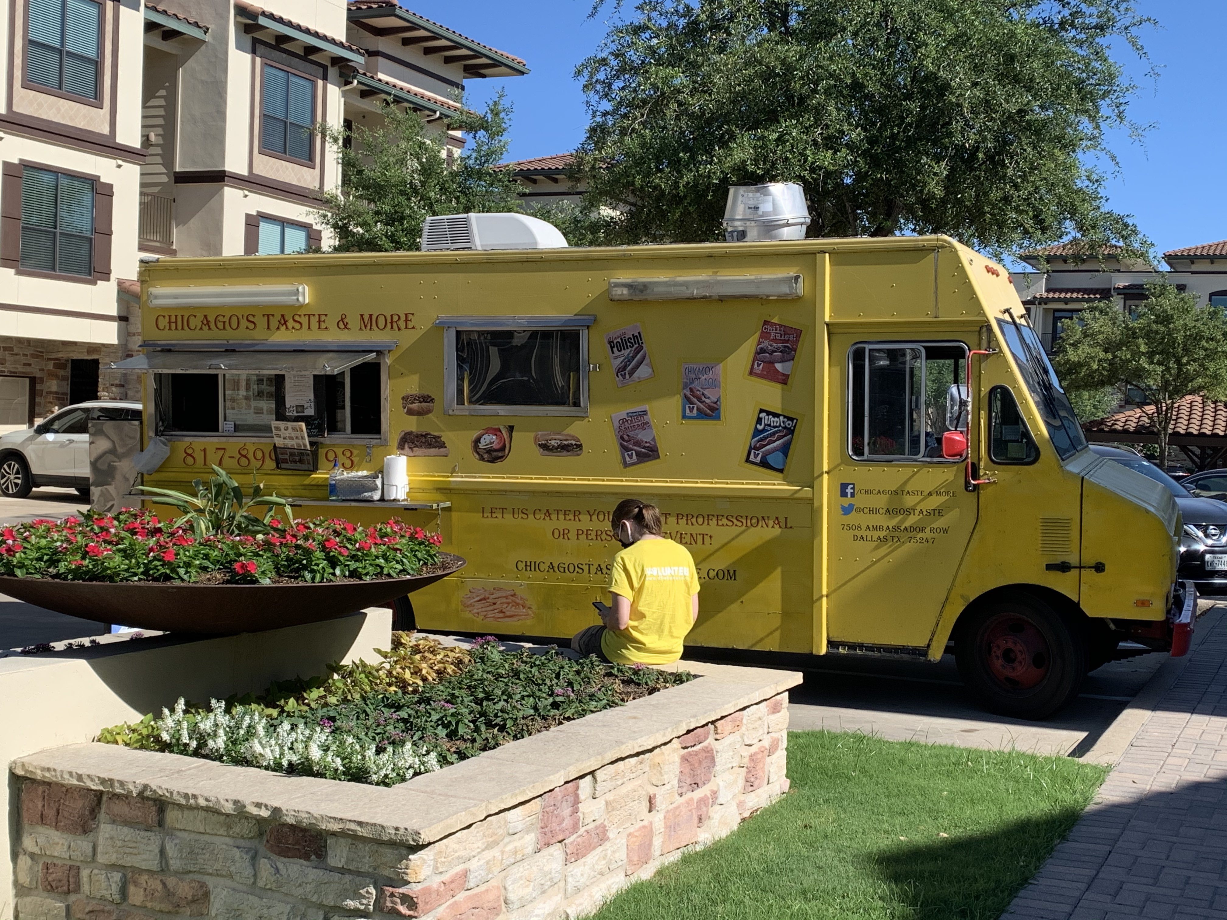 A Yellow food truck parked in a parking lot.